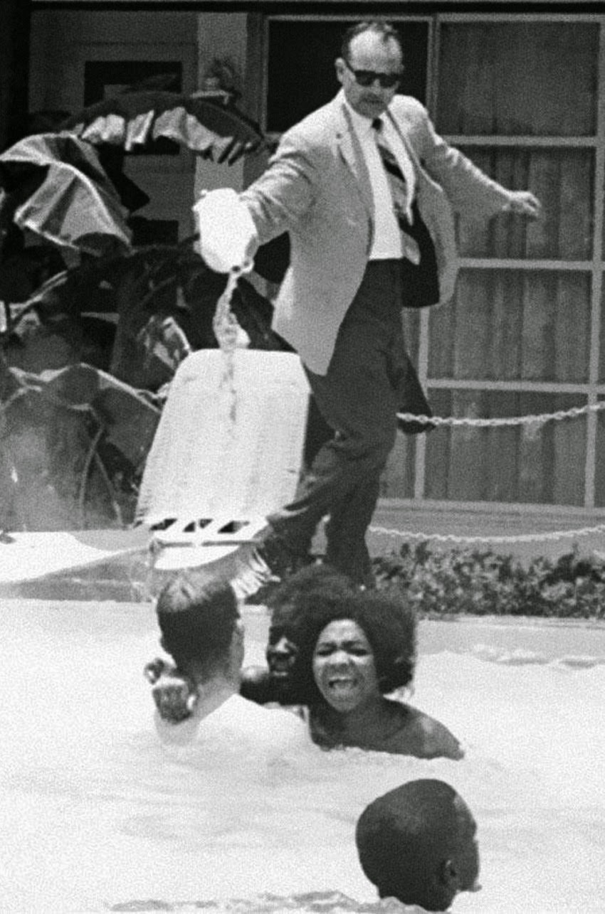 Motel manager pouring acid in the water when black people swam in his pool, 1964